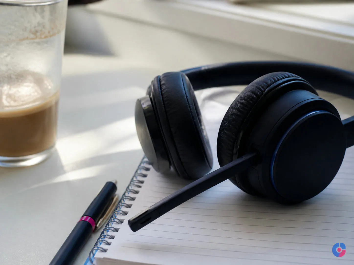 Headset and notebook on a desk between outbound appointment setting call blocks