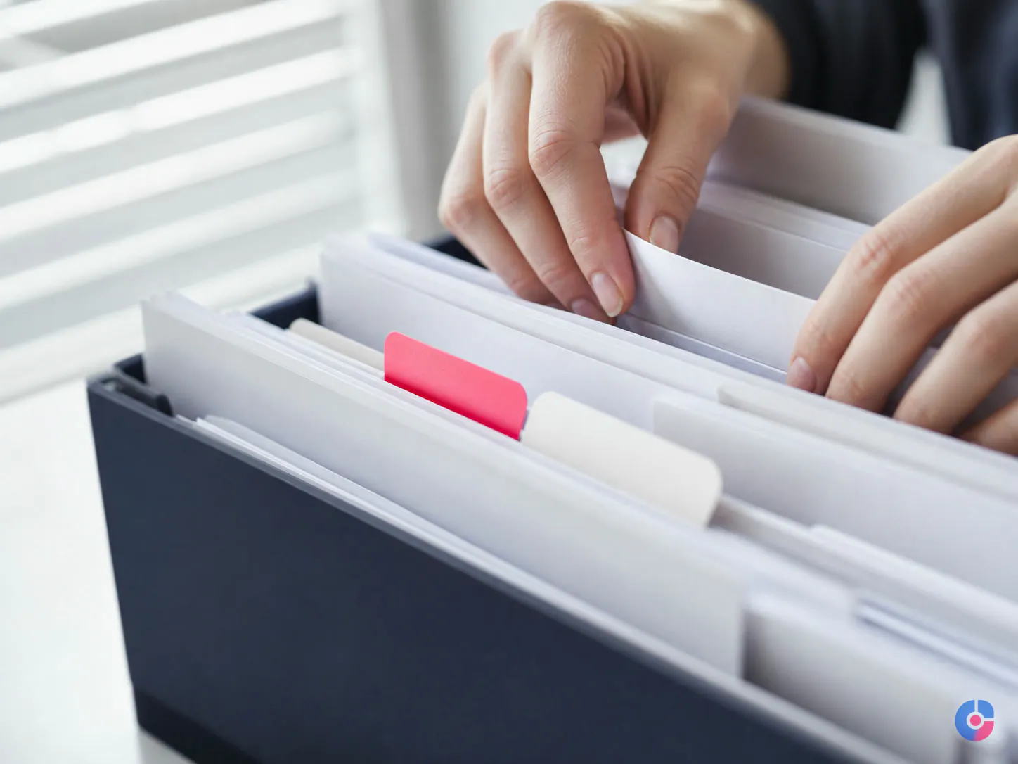Hands sorting denied claims into categories during medical billing follow-up work