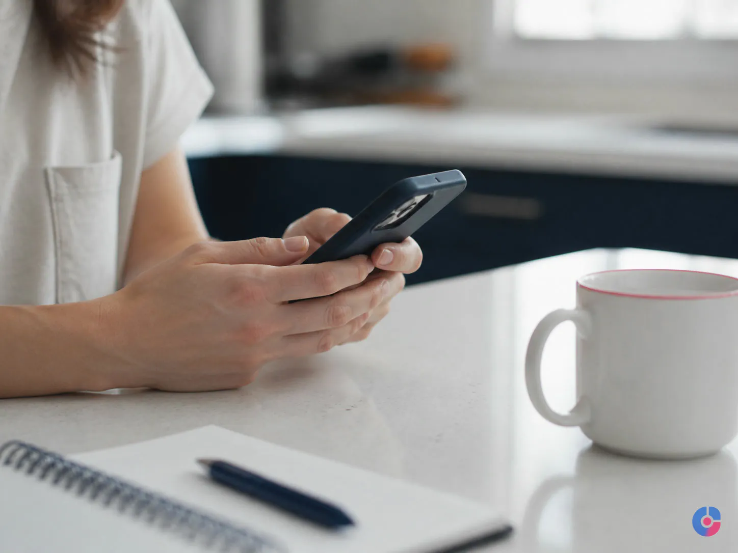 Customer contacting a support team from a kitchen counter on a mobile phone