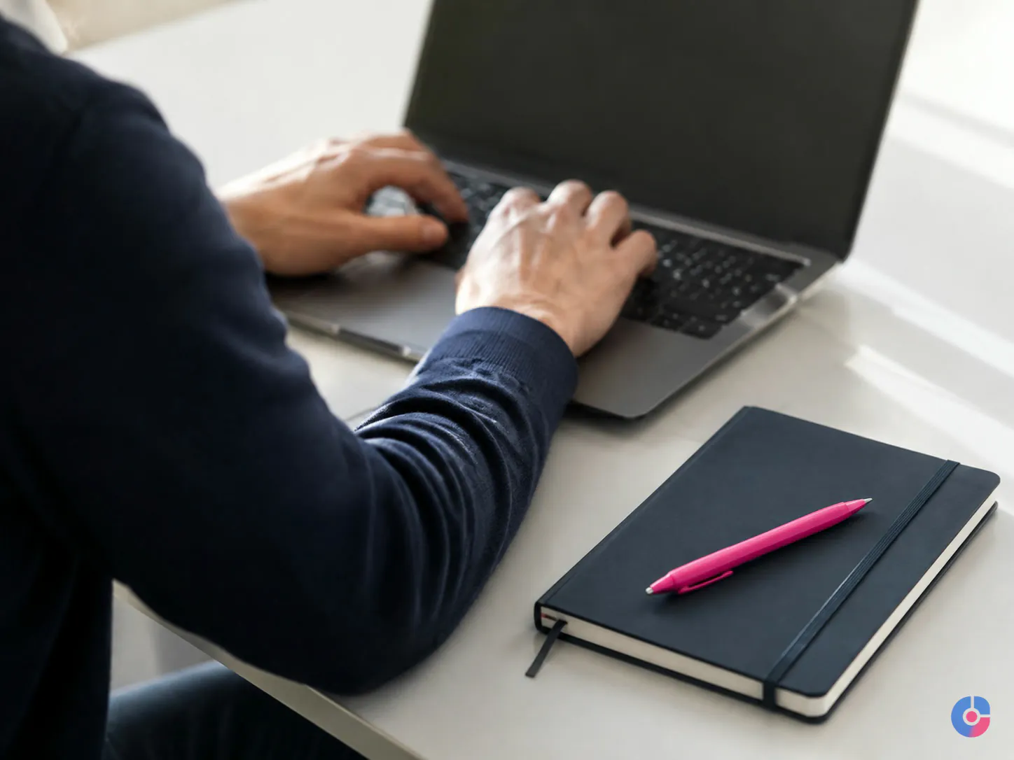 Assistant drafting approved email replies at a laptop in natural daylight