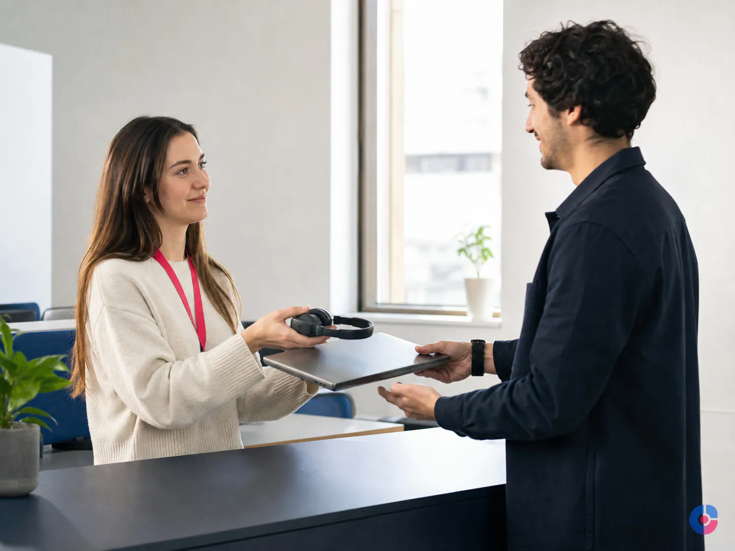 New hosted employee receiving provisioned laptop and headset on their first day