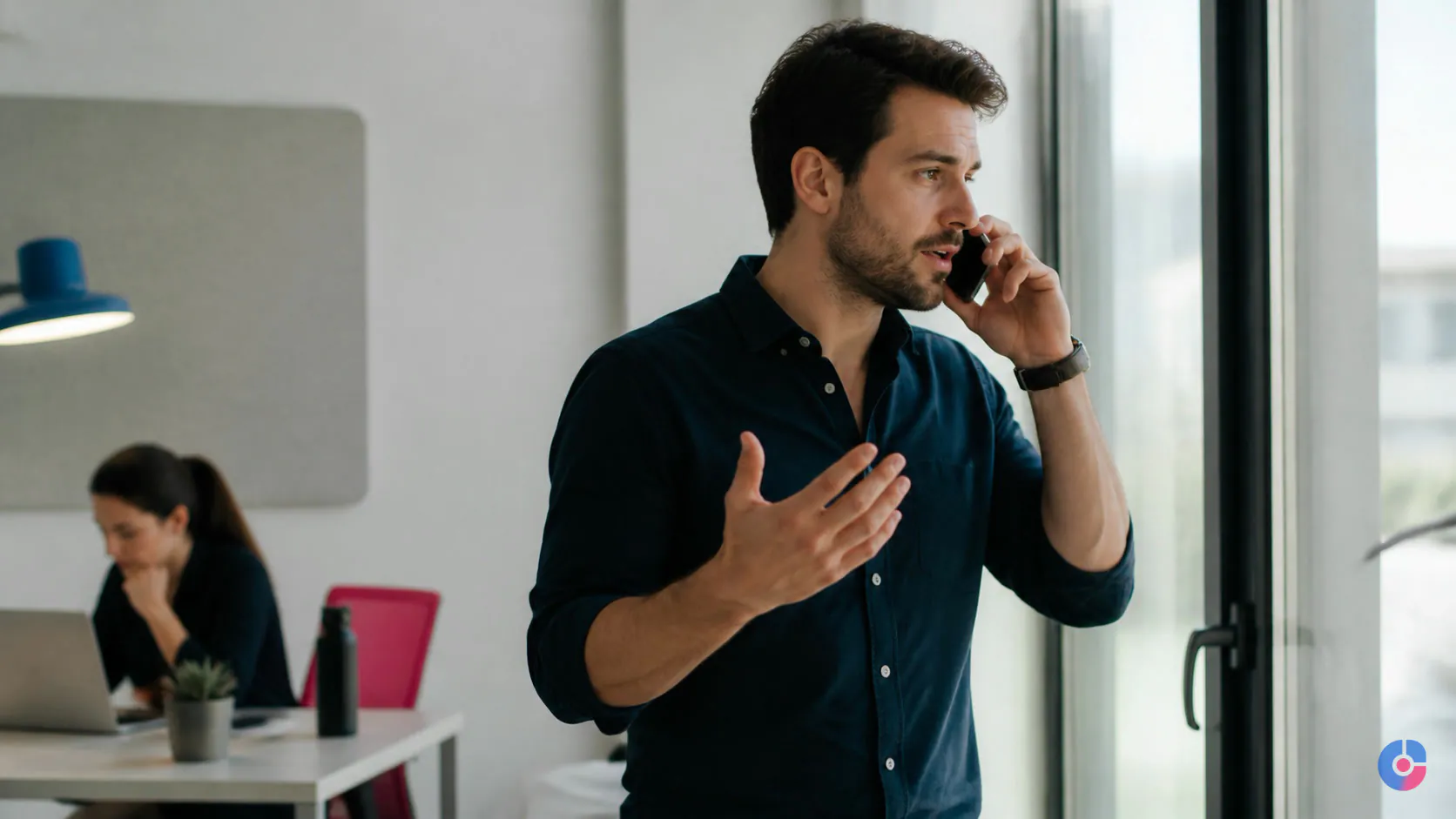Sales representative in conversation while a support colleague prepares pipeline work