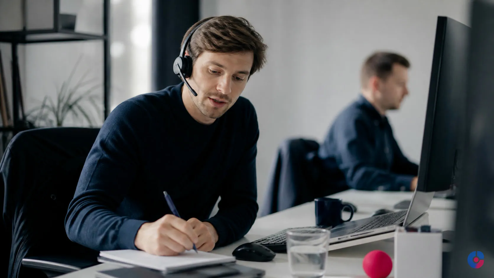Sales development representative taking notes during an outbound B2B prospecting call
