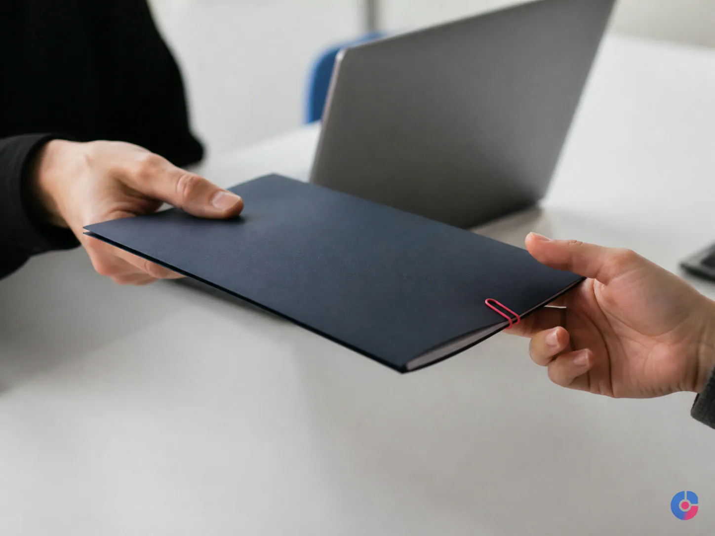 Close view of a task folder being handed over for delegation to an assistant