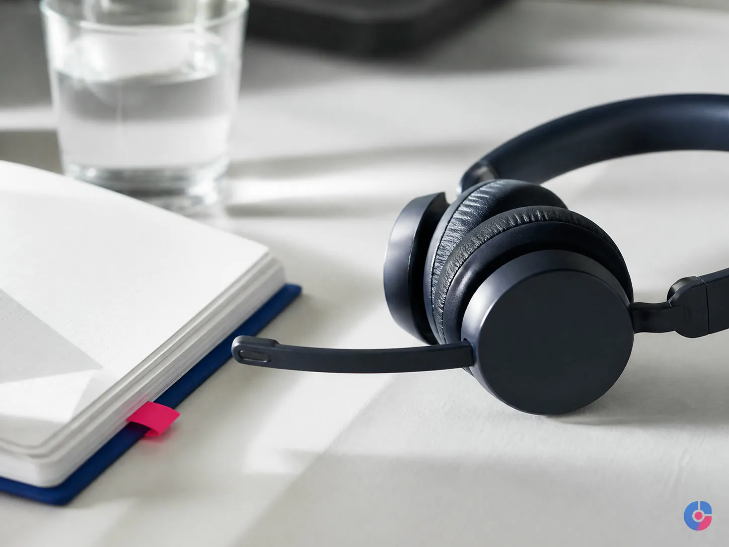 Headset and notes on a desk prepared for a remote voice assessment session