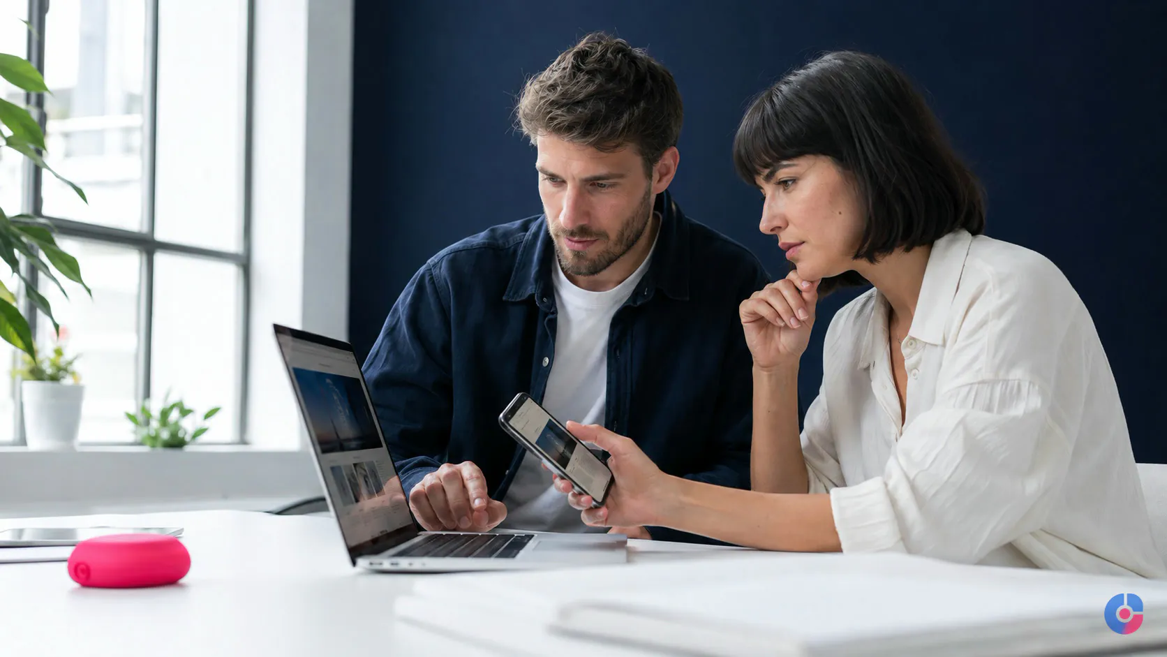 Developer and business owner reviewing a website on desktop and mobile together